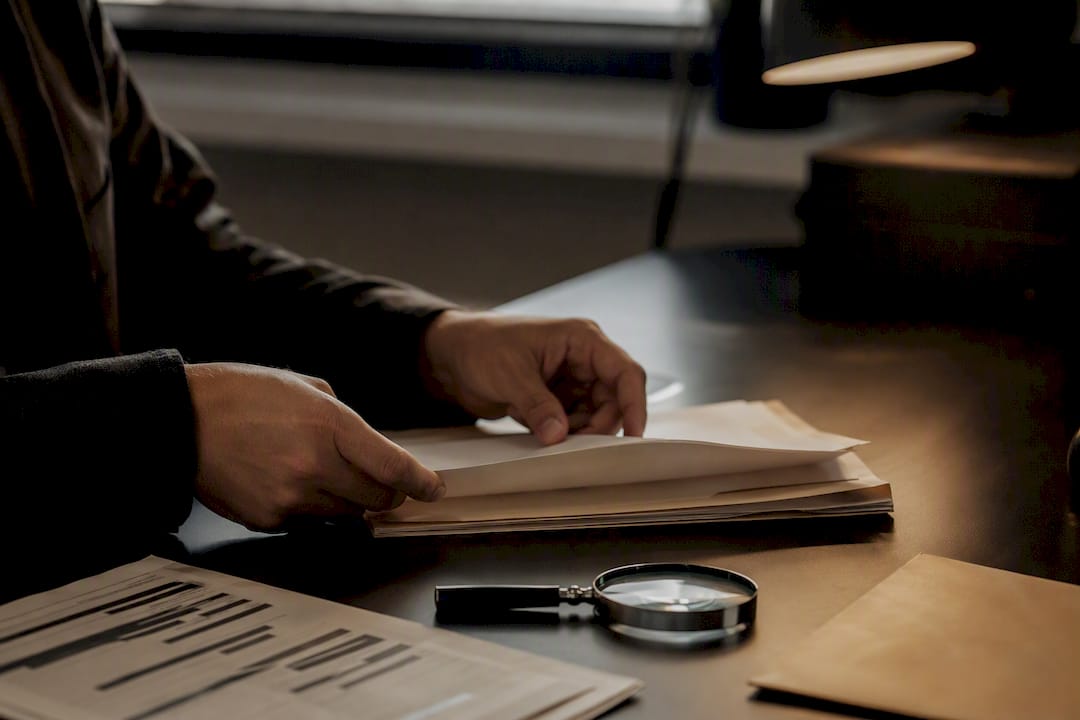 Hands sorting through cold case file