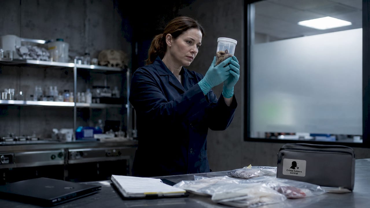 Forensic pathologist examining specimen in autopsy lab