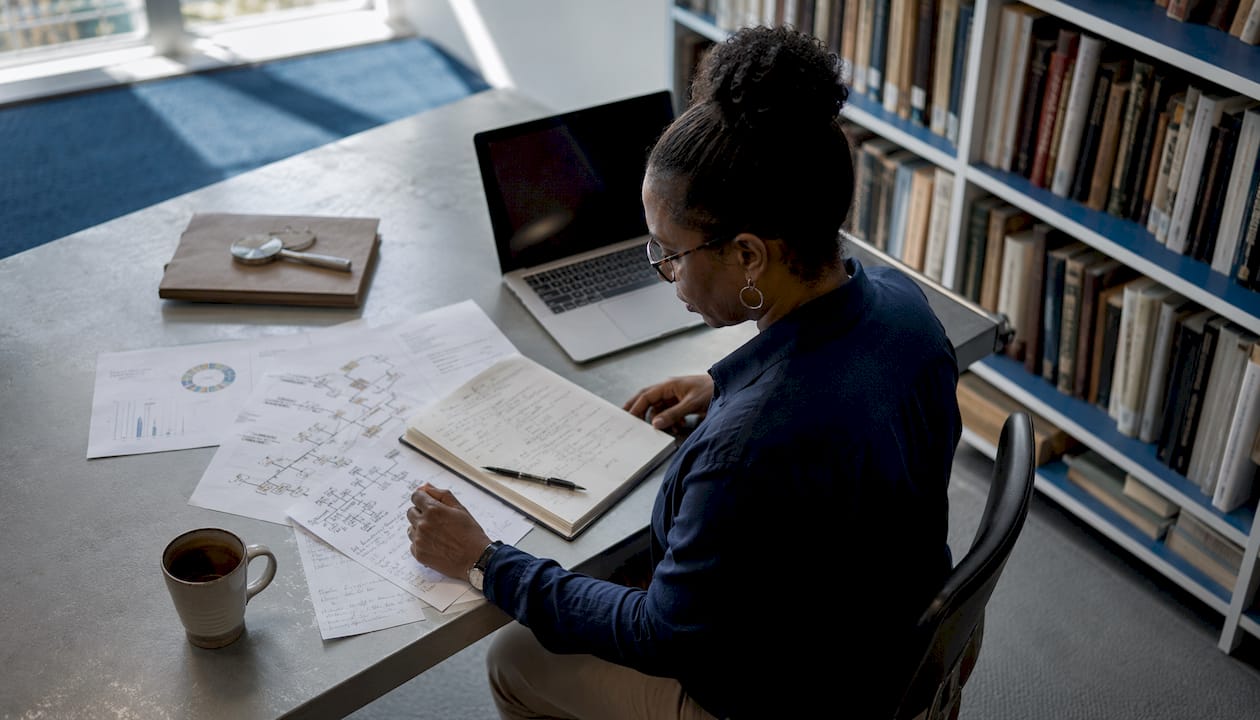 Genealogist reviewing DNA charts at desk
