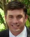 Director John death by force case profile photo